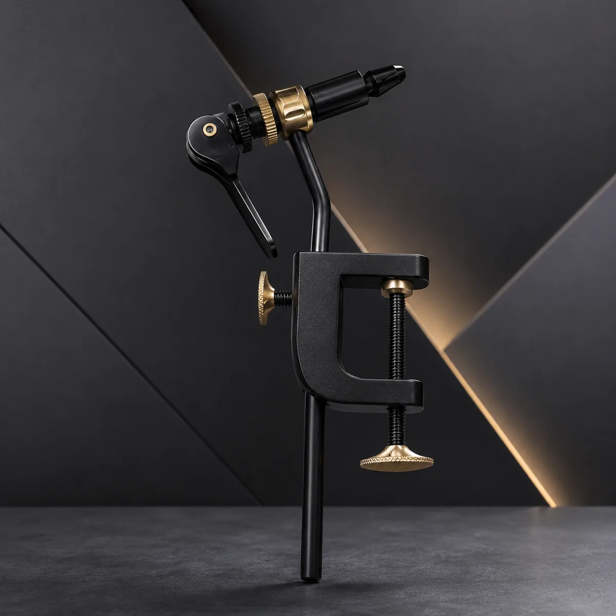 The Tailwater rotary vise from the side: C-clamp base with two brass thumb screws, brass-ringed rotating jaw head